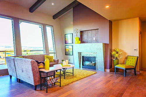 A  canted wall for the fireplace carries through the design used on the exterior into the interior space of the living room.