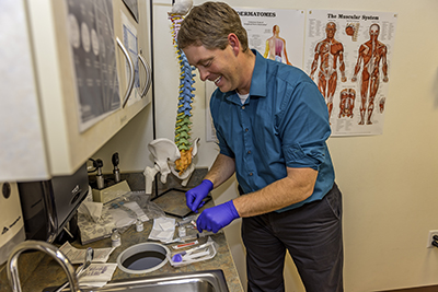 Montana native Dr. Craig Sweeney prepares for his next patient at the Great Falls Clinic. “Before you even have anything done, he makes you feel better because he is so positive,” remarks one of his thankful clients.