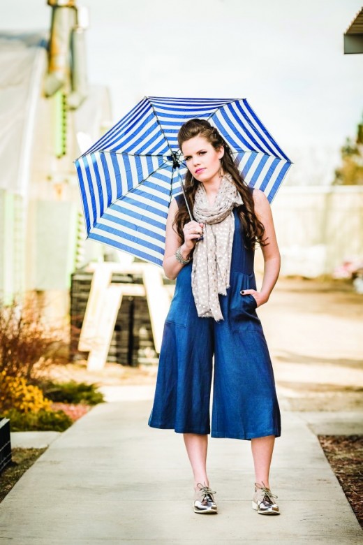 AMBER: Lush blue jumper, Seychelles mirrored Oxfords, GoodWorks silver leather and silver chain bracelet,  Printed Village polka dot scarf and silver dangle earrings with blue accent. All from Sole Sisters. (pg. 83). Models own umbrella.