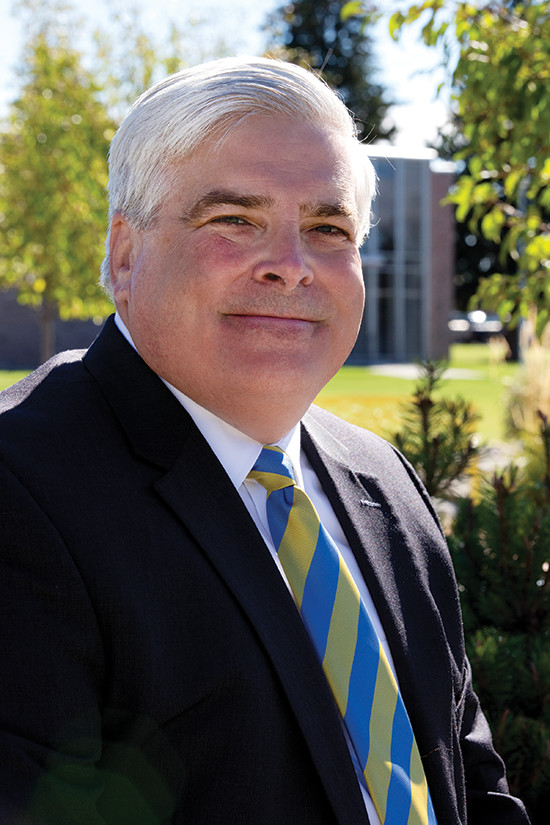 With school colors on his necktie, President Aretz is on the quad, ready for the hands-on challenge of running a bustling Catholic University.