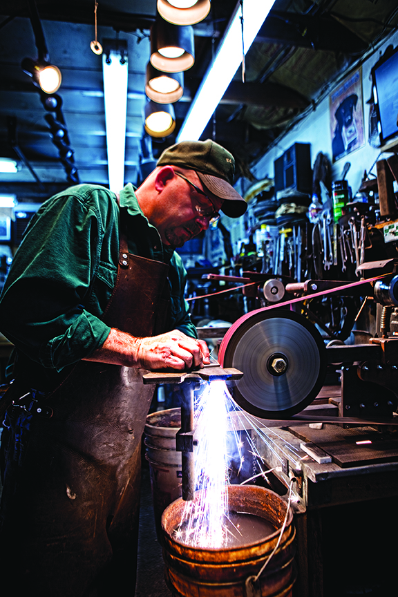 Ed Caffrey’s adventures in bladesmithing began at age 12. He and his best friend worked summers on farms, putting up hay, and catching and skinning beavers. When skinning the beaver, said Caffrey,“my friend sharpened his knife four times, and I sharpened mine five. From that point, the search was on for a better knife. Photo by Jim Wells